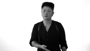 Black and white photo of founder, Niko Kacey, a queer, asian fashion footwear designer