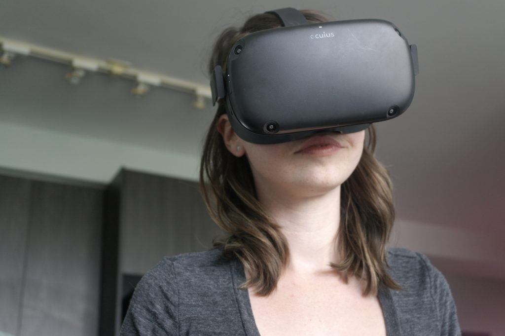 Image of woman looking through black VR glasses