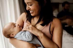 Image of woman of colour holding a baby