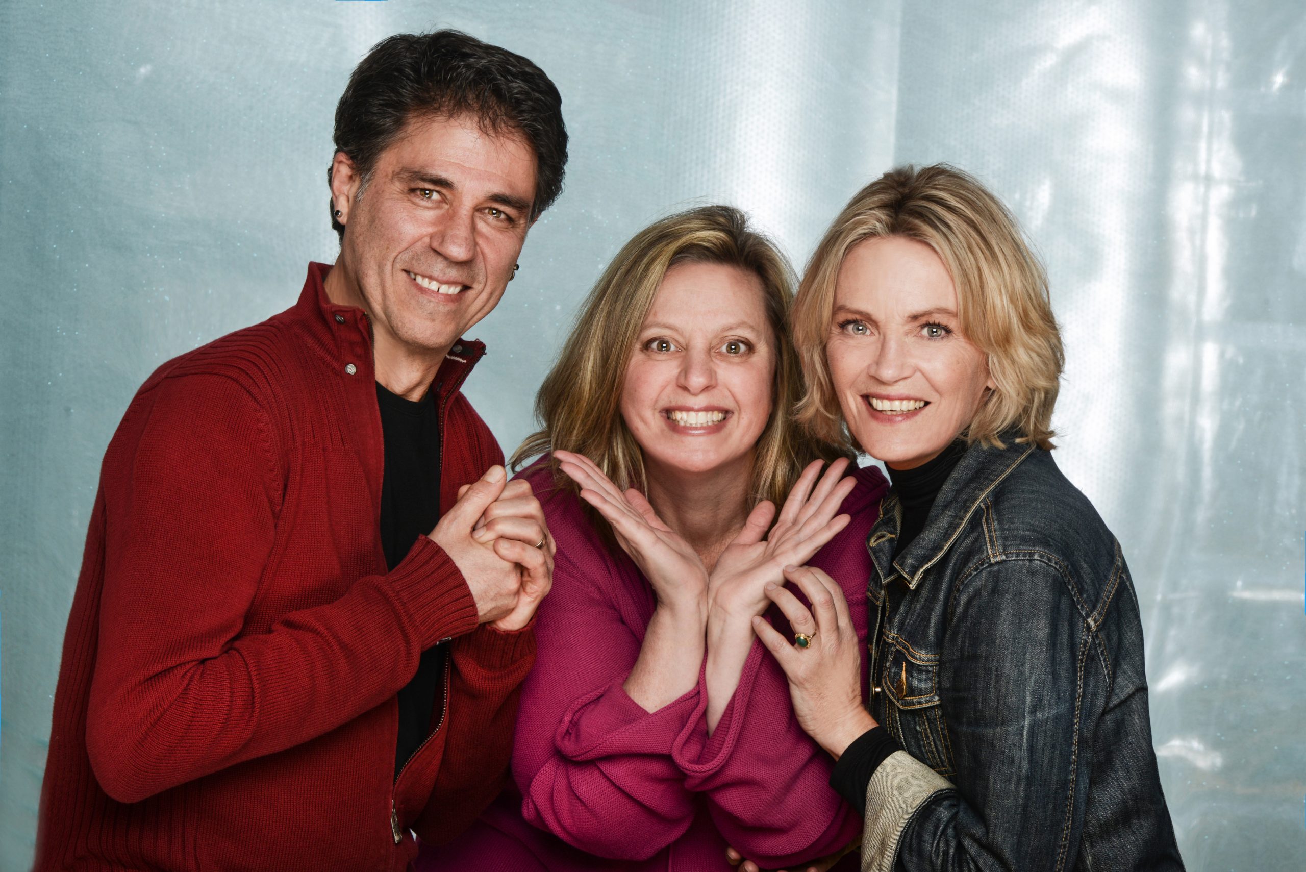 Photo of three people. A man, two women.